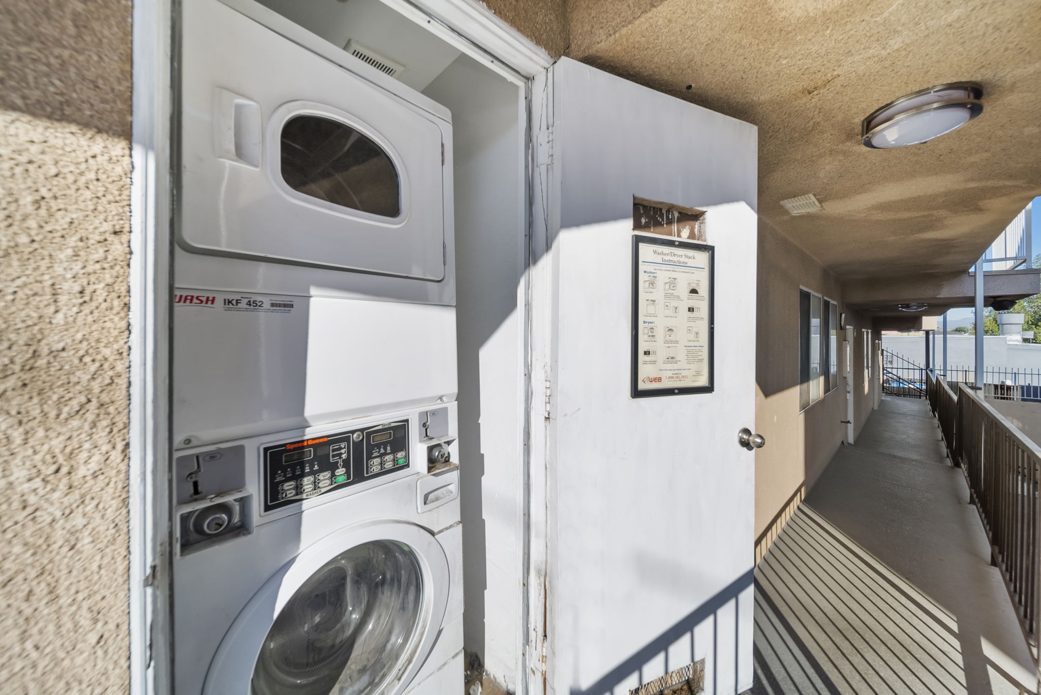 A washing machine is installed in a small room.